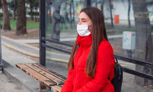 woman-wearing-surgical-mask-bus-stop.jpg